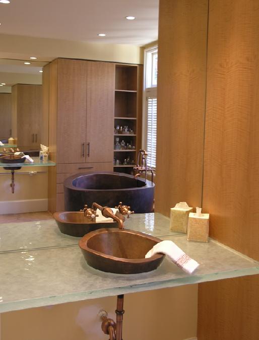 Copper sink on glass countertop